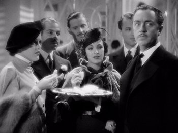 Movie still from “My Man Godfrey” (1936), directed by Gregory La Cava – A group of people standing around each other holding a tray; Medium shot, High angle