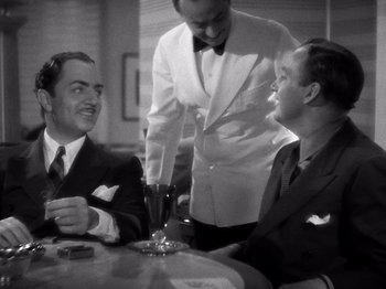 Movie still from “My Man Godfrey” (1936), directed by Gregory La Cava – Three men are sitting at a table with a glass of wine; Medium shot, Over the shoulder angle