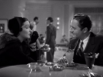 Movie still from “My Man Godfrey” (1936), directed by Gregory La Cava – A man and a woman sitting at a table in a restaurant; Medium shot, Over the shoulder angle