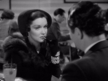 Movie still from “My Man Godfrey” (1936), directed by Gregory La Cava – A woman in a black hat and a man in a black suit; Close Up shot, Over the shoulder angle