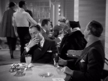 Movie still from “My Man Godfrey” (1936), directed by Gregory La Cava – A group of people sitting around a table; Medium shot, High angle
