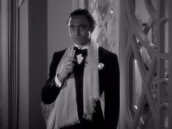 Movie still from “My Man Godfrey” (1936), directed by Gregory La Cava – A black and white photo of a man in a suit and bow tie; Medium shot, Low angle