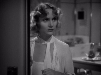 Movie still from “My Man Godfrey” (1936), directed by Gregory La Cava – A black - and - white photo of a woman looking at a mirror; Close Up shot, Over the shoulder angle