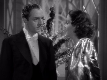 Movie still from “My Man Godfrey” (1936), directed by Gregory La Cava – A man and a woman standing next to each other in front of a christmas tree; Medium shot, Low angle