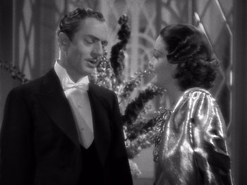 Movie still from “My Man Godfrey” (1936), directed by Gregory La Cava – A man and a woman standing next to each other in front of a christmas tree; Medium shot, Low angle