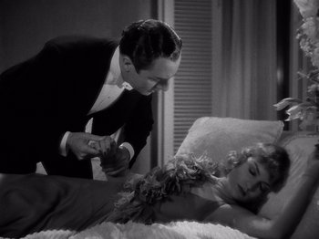 Movie still from “My Man Godfrey” (1936), directed by Gregory La Cava – A man and a woman in formal wear on a bed; Medium shot, High angle