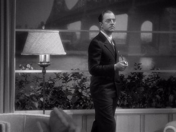 Movie still from “My Man Godfrey” (1936), directed by Gregory La Cava – A black and white photo of a man in a suit and tie; Medium shot, Low angle