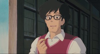 Movie still from “My Neighbor Totoro” (1988), directed by Hayao Miyazaki – A man with glasses is holding something in his hand; Close Up shot, Over the shoulder angle