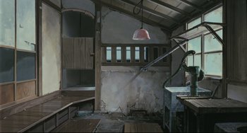 Movie still from “My Neighbor Totoro” (1988), directed by Hayao Miyazaki – An unfinished room with a ceiling light hanging from the side of the room; Wide shot, Low angle