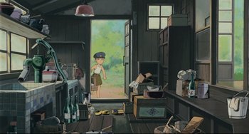 Movie still from “My Neighbor Totoro” (1988), directed by Hayao Miyazaki – An illustration of a woman in a room with boxes; Wide shot, High angle