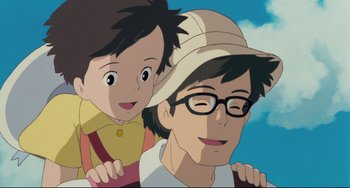Movie still from “My Neighbor Totoro” (1988), directed by Hayao Miyazaki – A man and a boy are smiling for the camera; Close Up shot, Low angle