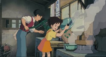 Movie still from “My Neighbor Totoro” (1988), directed by Hayao Miyazaki – An animated scene of a boy and a girl cooking in a kitchen; Medium shot, Low angle