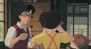 Movie still from “My Neighbor Totoro” (1988), directed by Hayao Miyazaki – A man and a woman are talking to each other in a room; Medium shot, Over the shoulder angle