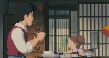 Movie still from “My Neighbor Totoro” (1988), directed by Hayao Miyazaki – A man and a little girl sitting at a dining table; Medium shot, Over the shoulder angle