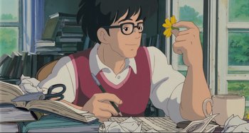 Movie still from “My Neighbor Totoro” (1988), directed by Hayao Miyazaki – A man sitting at a table holding a yellow flower; Medium shot, Low angle