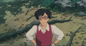 Movie still from “My Neighbor Totoro” (1988), directed by Hayao Miyazaki – An animated picture of a man in a red vest; Medium shot, High angle