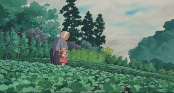 Movie still from “My Neighbor Totoro” (1988), directed by Hayao Miyazaki – An old woman and a small child are in a field; Wide shot, Low angle