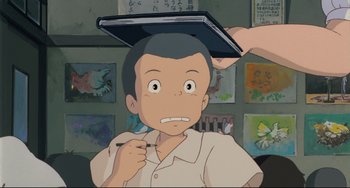 Movie still from “My Neighbor Totoro” (1988), directed by Hayao Miyazaki – An animated picture of a man with a tablet on his head; Close Up shot, High angle
