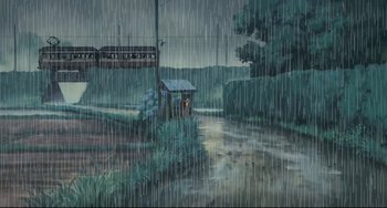 Movie still from “My Neighbor Totoro” (1988), directed by Hayao Miyazaki – A painting of a train on the tracks in the rain; Extreme Wide shot, High angle