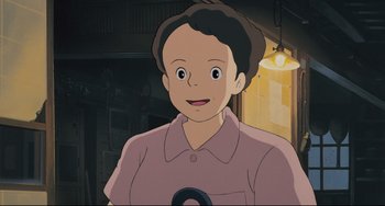 Movie still from “My Neighbor Totoro” (1988), directed by Hayao Miyazaki – A young boy is smiling for the camera; Close Up shot, Over the shoulder angle