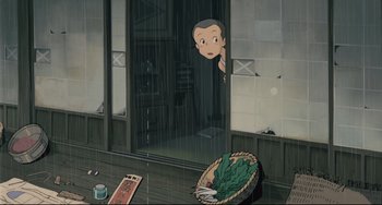 Movie still from “My Neighbor Totoro” (1988), directed by Hayao Miyazaki – An animated scene of a boy looking out of a window; Wide shot, High angle