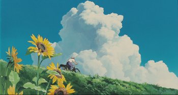 Movie still from “My Neighbor Totoro” (1988), directed by Hayao Miyazaki – A man riding a bike on top of a green hill; Extreme Wide shot, Low angle