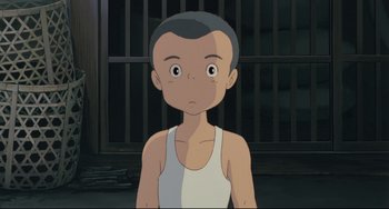 Movie still from “My Neighbor Totoro” (1988), directed by Hayao Miyazaki – A young man in a white tank top is in front of a jail cell; Close Up shot, High angle
