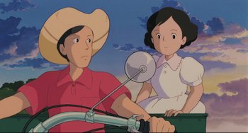 Movie still from “My Neighbor Totoro” (1988), directed by Hayao Miyazaki – A man and a woman riding a bike together; Medium shot, Low angle