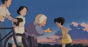 Movie still from “My Neighbor Totoro” (1988), directed by Hayao Miyazaki – An animated scene of a woman holding a small bird; Wide shot, Low angle