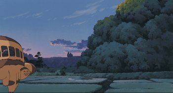 Movie still from “My Neighbor Totoro” (1988), directed by Hayao Miyazaki – A painting of a field with a castle in the background; Extreme Wide shot, Low angle