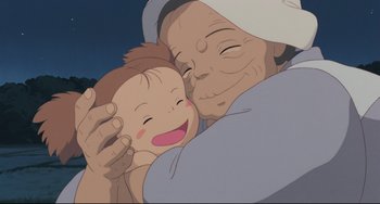Movie still from “My Neighbor Totoro” (1988), directed by Hayao Miyazaki – An older woman holding a baby in her arms; Close Up shot, Low angle