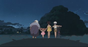 Movie still from “My Neighbor Totoro” (1988), directed by Hayao Miyazaki – A group of people standing in front of a tree at night; Wide shot, Low angle
