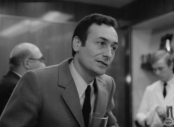 Movie still from “My Night at Maud's” (1969), directed by Éric Rohmer – Black and white photograph of a man in a suit holding a glass of wine; Close Up shot, Low angle