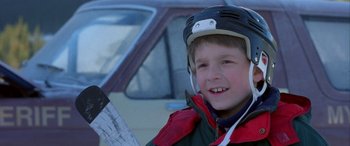 Movie still from “Mystery, Alaska” (1999), directed by Jay Roach – A young boy wearing a helmet and holding an ax; Close Up shot, Low angle