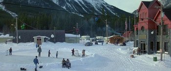 Movie still from “Mystery, Alaska” (1999), directed by Jay Roach – A group of skiers and snowboarders in the snow; Extreme Wide shot, High angle