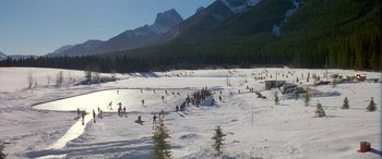 Movie still from “Mystery, Alaska” (1999), directed by Jay Roach – A group of skiers on a snow covered slope; Extreme Wide shot, High angle
