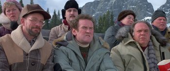 Movie still from “Mystery, Alaska” (1999), directed by Jay Roach – A group of men sitting next to each other on top of a hill; Close Up shot, Low angle