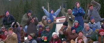 Movie still from “Mystery, Alaska” (1999), directed by Jay Roach – A group of people sitting in a stadium watching a game; Wide shot, High angle
