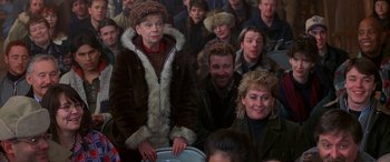 Movie still from “Mystery, Alaska” (1999), directed by Jay Roach – A group of people sitting in front of each other; Medium shot, High angle