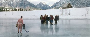 Movie still from “Mystery, Alaska” (1999), directed by Jay Roach – A group of people standing on top of an ice rink; Extreme Wide shot, High angle