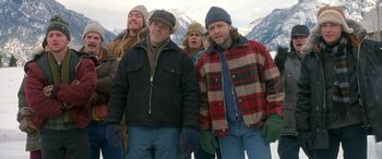 Movie still from “Mystery, Alaska” (1999), directed by Jay Roach – A group of men standing next to each other in the snow; Medium shot, Low angle