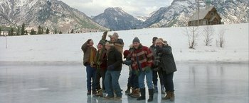 Movie still from “Mystery, Alaska” (1999), directed by Jay Roach – A group of people standing on top of an ice rink; Wide shot, High angle