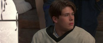 Movie still from “Mystery, Alaska” (1999), directed by Jay Roach – A young man is looking into the distance; Close Up shot, High angle