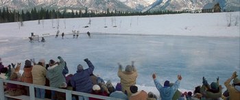 Movie still from “Mystery, Alaska” (1999), directed by Jay Roach – A group of people standing on top of an ice rink; Extreme Wide shot, High angle
