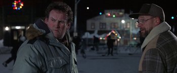 Movie still from “Mystery, Alaska” (1999), directed by Jay Roach – A man standing in the middle of the street at night; Close Up shot, Over the shoulder angle