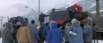 Movie still from “Mystery, Alaska” (1999), directed by Jay Roach – A group of people standing around a train; Wide shot, High angle