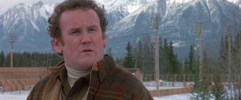 Movie still from “Mystery, Alaska” (1999), directed by Jay Roach – A person wearing a jacket near some trees; Close Up shot, Low angle