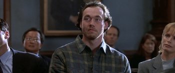 Movie still from “Mystery, Alaska” (1999), directed by Jay Roach – A person wearing a plaid shirt; Close Up shot, Over the shoulder angle