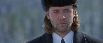Movie still from “Mystery, Alaska” (1999), directed by Jay Roach – A person wearing a suit and a fur hat; Close Up shot, Over the shoulder angle