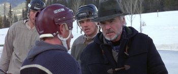 Movie still from “Mystery, Alaska” (1999), directed by Jay Roach – A group of men standing next to each other in the snow; Close Up shot, Over the shoulder angle